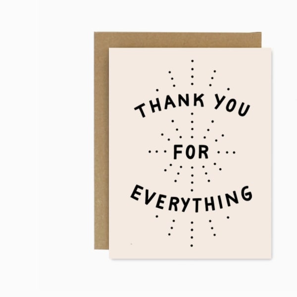 Thank you greeting card with black text on a cream front and brown envelope