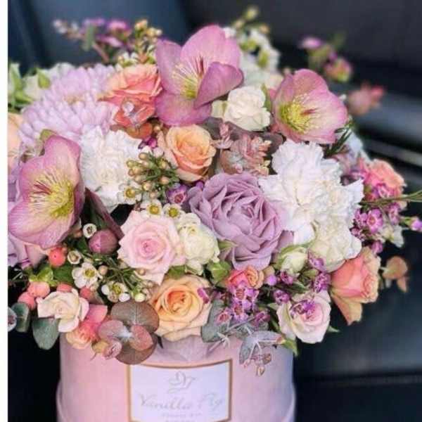 Pink and lavender mixed bouquet in a round pink box