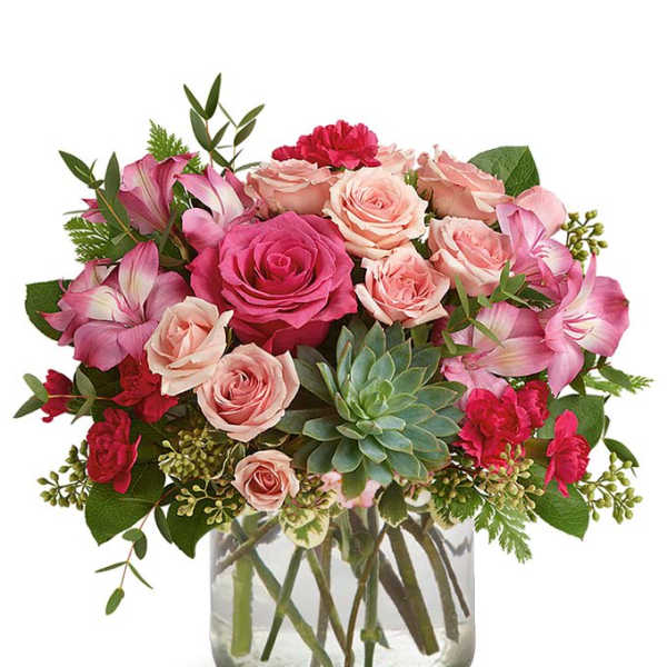 Pink roses and carnations in a glass vase with a succulent accent