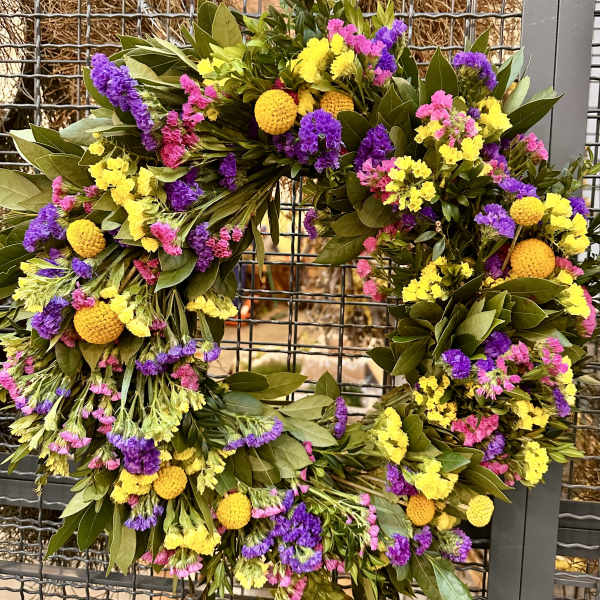 Colorful floral wreath with yellow, purple, and pink blooms