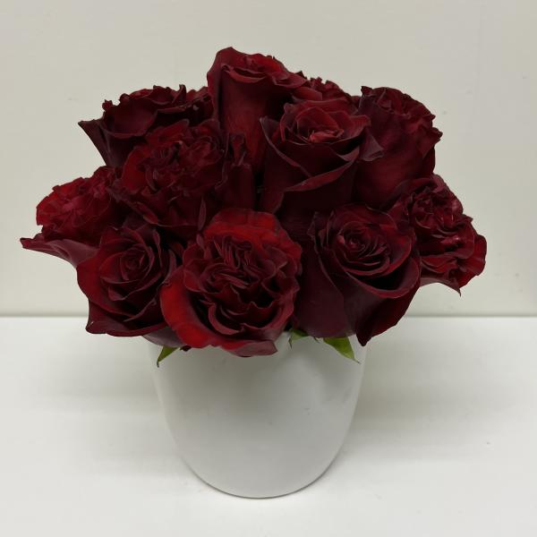 Bouquet of deep red roses in a white vase