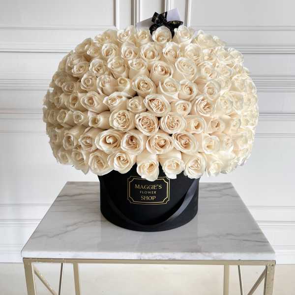Large bouquet of cream roses in a black hatbox