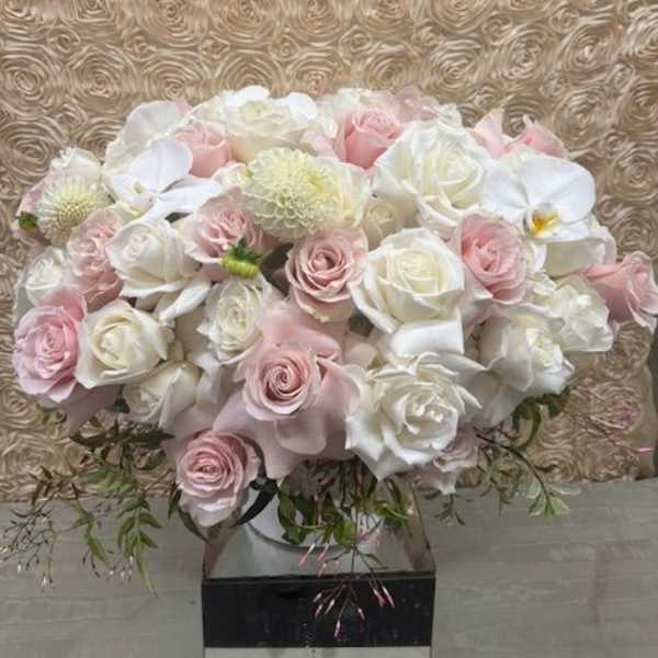 Bouquet of pale pink and white roses with orchids and mums