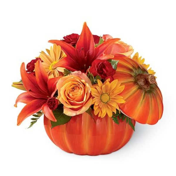 Orange floral arrangement in a pumpkin-shaped container