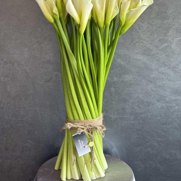 Bouquet of white calla lilies tied with twine