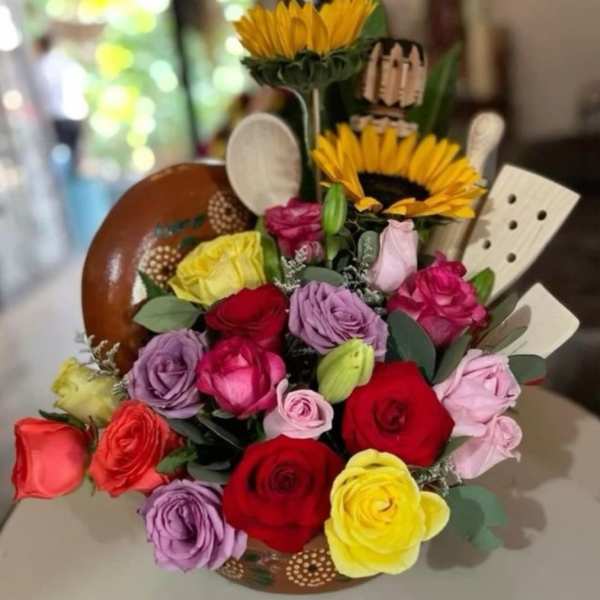 Colorful bouquet with roses and sunflowers in a decorative holder