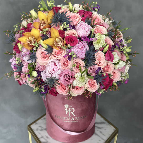Large mixed bouquet in a pink velvet hatbox with roses and orchids