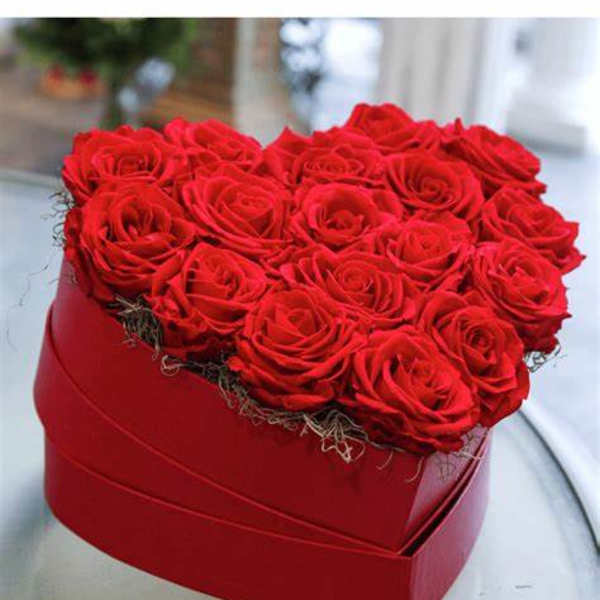 Heart-shaped red box filled with tightly packed red roses
