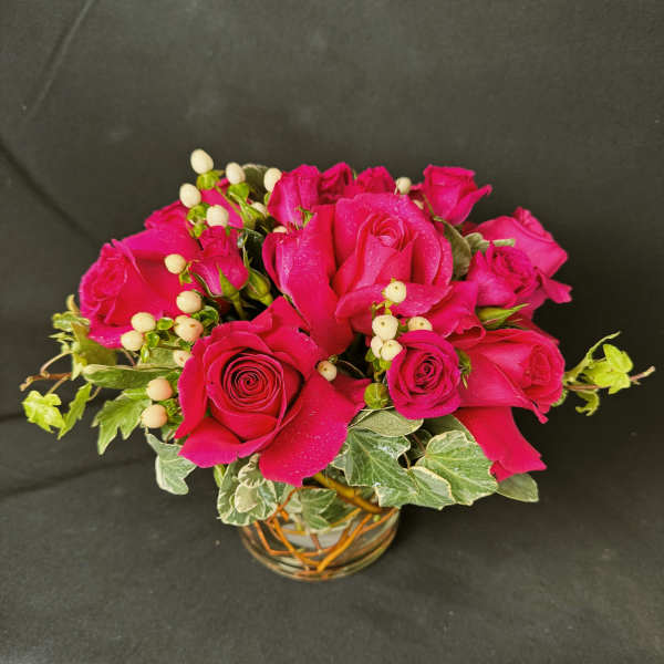 Pink rose bouquet in a small glass vase