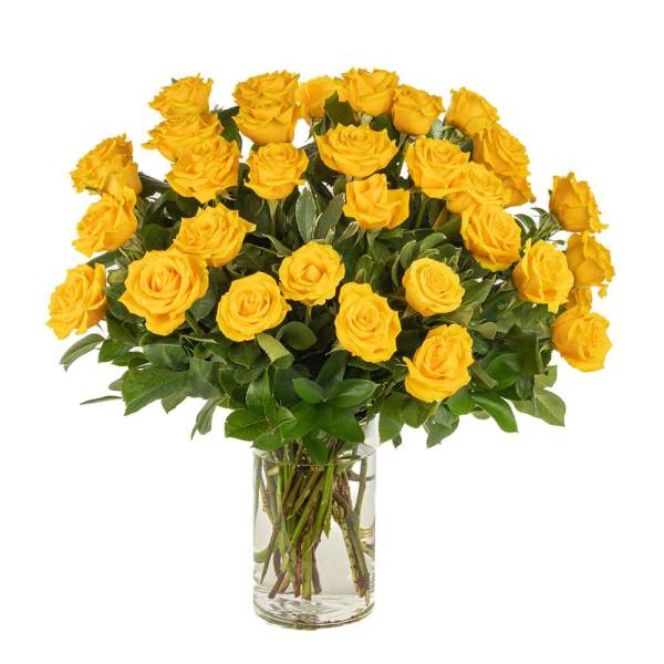Large bouquet of yellow roses arranged in a clear glass vase