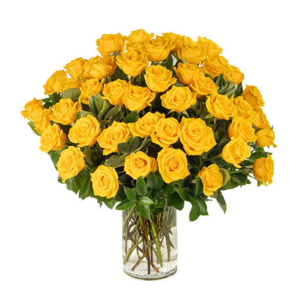 Large arrangement of yellow roses in a clear glass vase