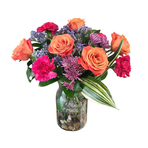Bouquet of orange roses, pink carnations, and purple flowers in a glass vase