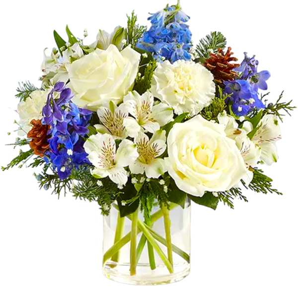 White roses and blue flowers arranged in a clear glass vase