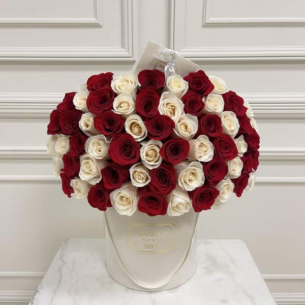 Bouquet of red and white roses in a white hatbox