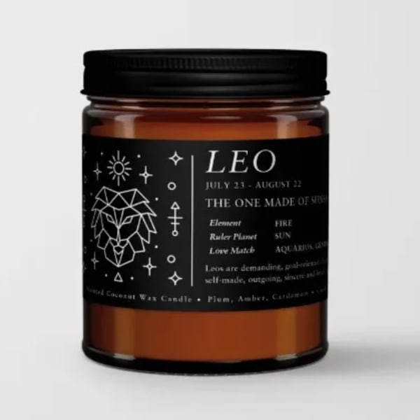 Amber candle jar with a black label and Leo zodiac design