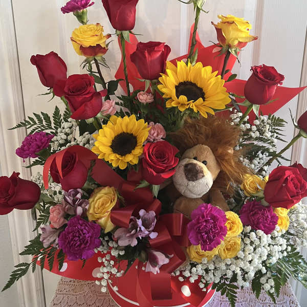 Bouquet of red roses, sunflowers, and a plush lion in a red box