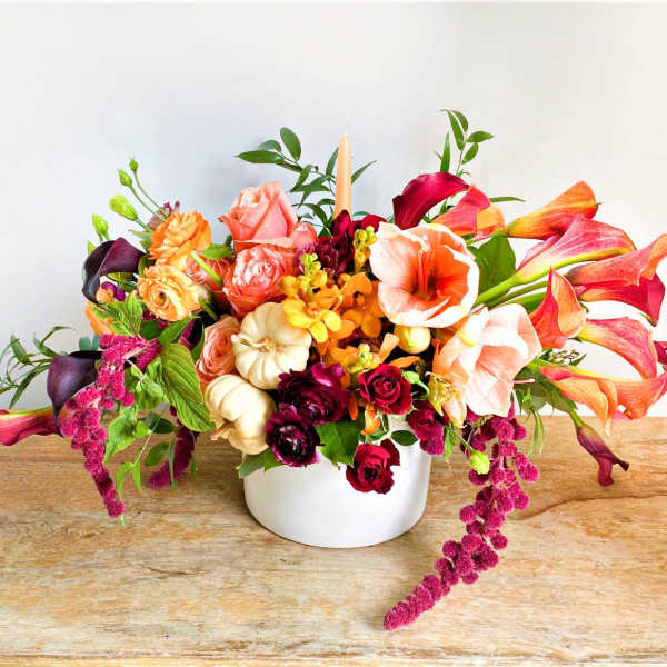 Colorful mixed flower arrangement in a white vase