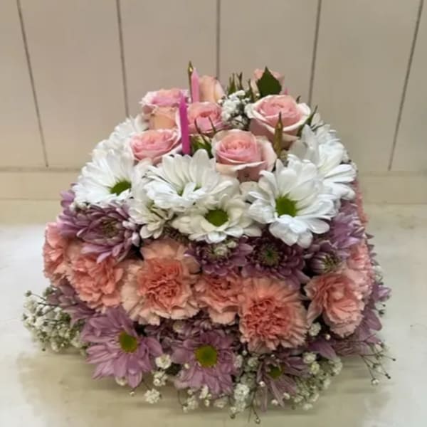 Pink roses and white daisies arranged in a square floral display