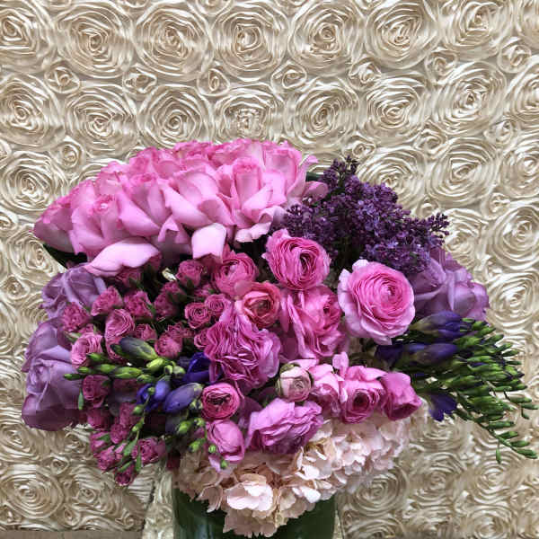 Pink and purple bouquet in a green vase