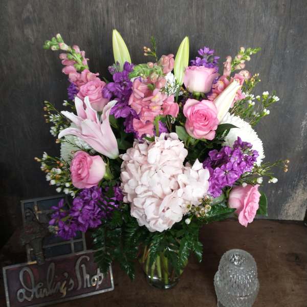 Pink and purple mixed bouquet in a glass vase
