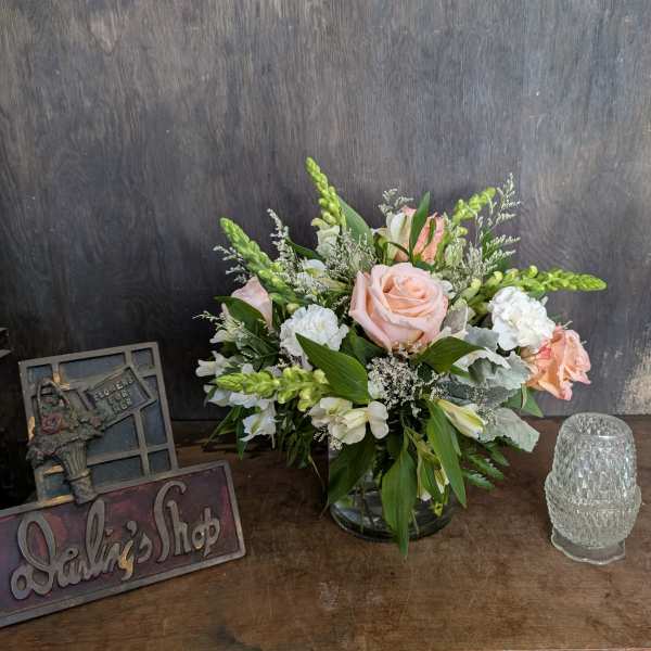 Pink and white floral arrangement in a glass vase