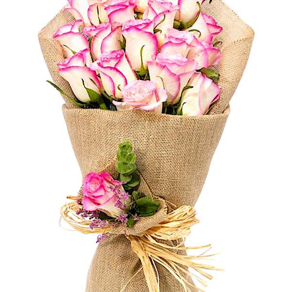 Bouquet of pink-edged white roses wrapped in burlap
