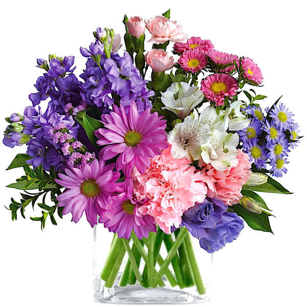 Mixed bouquet of purple, pink, white, and blue flowers in a clear glass vase