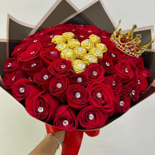 Bouquet of red roses with gold-wrapped chocolates and a jeweled crown