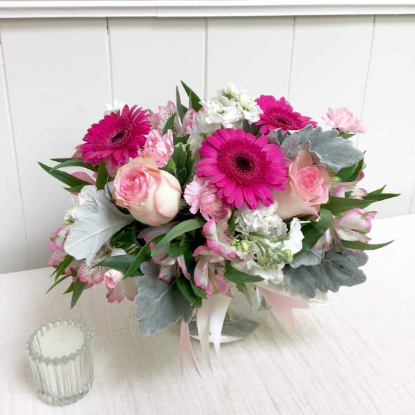 Pink and white bouquet with gerbera daisies and roses in a glass vase