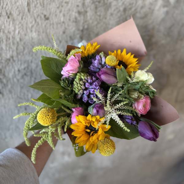Hand-tied bouquet with sunflowers, purple and pink blooms
