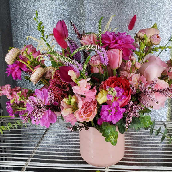 Pink mixed bouquet in a blush vase with calla lilies and dahlias