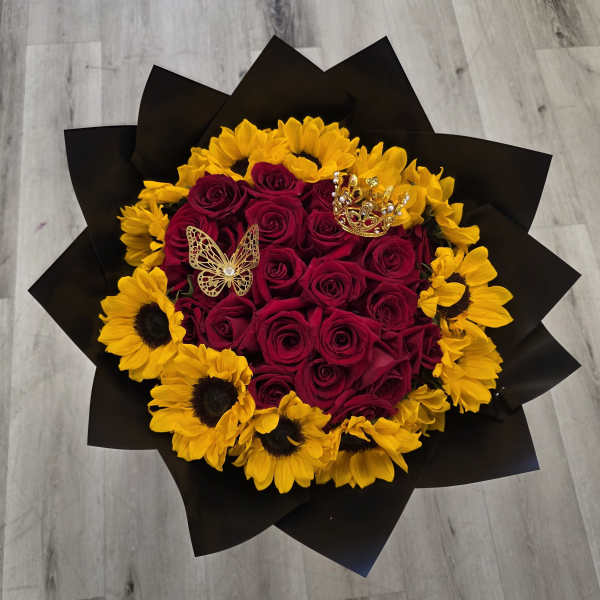 Bouquet of red roses and yellow sunflowers wrapped in black paper