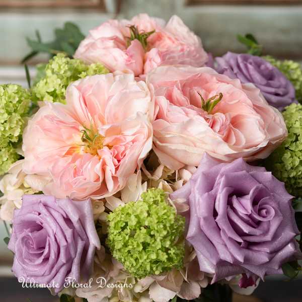 Bouquet of pink and lavender roses with green hydrangea clusters