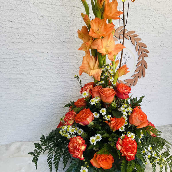 Tall orange floral arrangement with roses and gladiolus