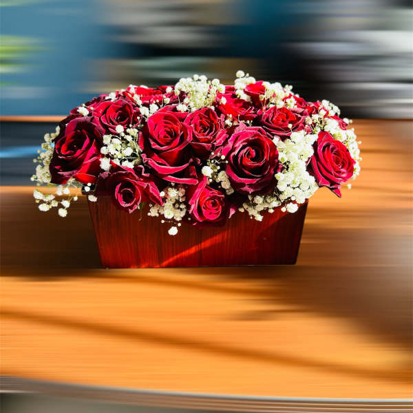 Red roses and white baby's breath in a wooden box
