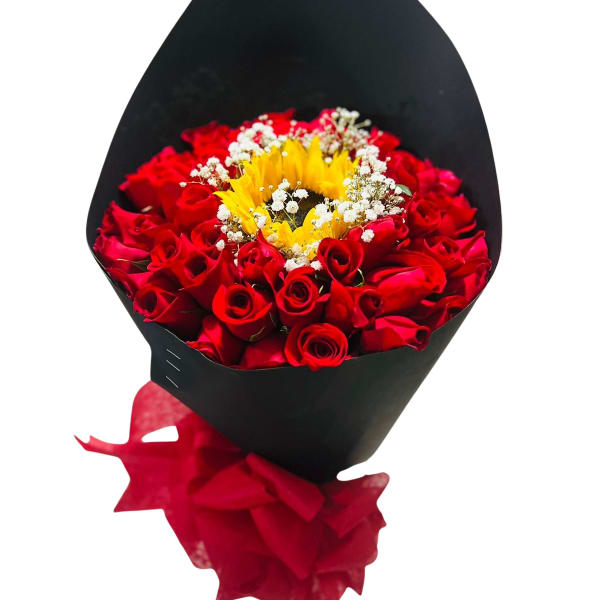 Bouquet of red roses with a sunflower center in black wrap