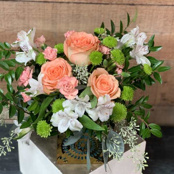 Peach roses with white alstroemeria and green pompons in a decorative box