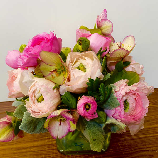 Pink and cream ranunculus bouquet in a glass vase