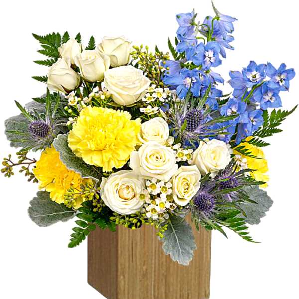 Bouquet of white roses, yellow blooms, and blue flowers in a wooden box