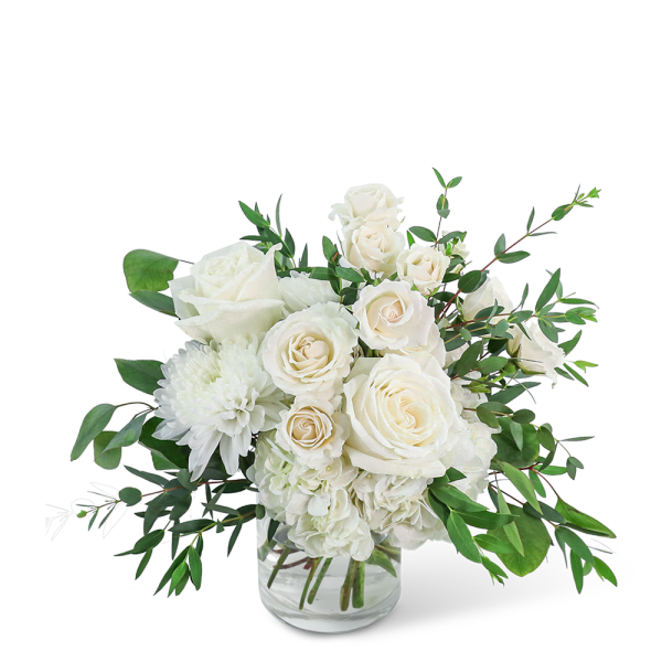 White roses and chrysanthemums in a clear glass vase