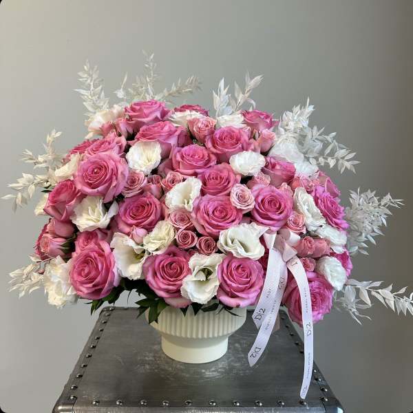 Pink and white rose bouquet in a white vase