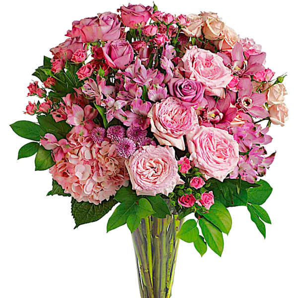 Pink rose and orchid bouquet in a clear glass vase