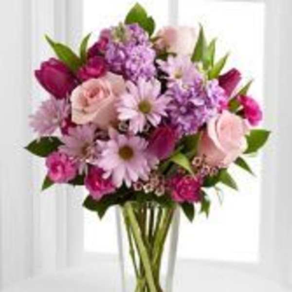 Pink and purple mixed bouquet in a clear glass vase
