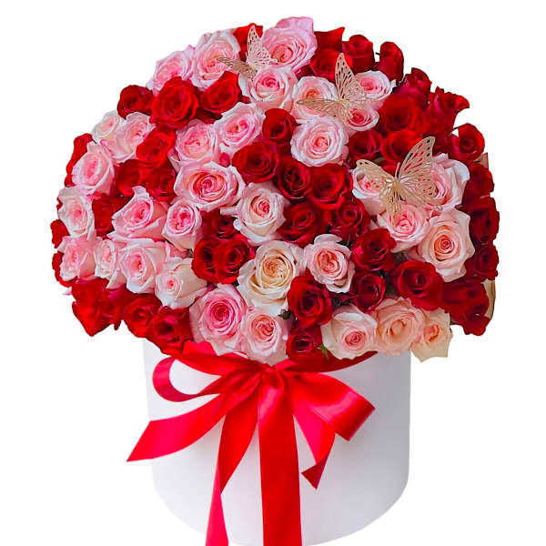 Bouquet of red and pink roses in a white hat box with a red ribbon