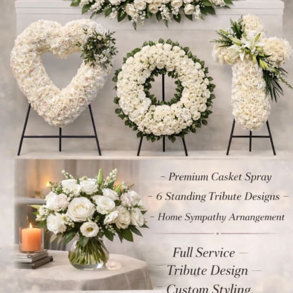 White funeral floral set with casket spray, heart, wreath, cross tributes, and vase bouquet on a soft neutral backdrop.