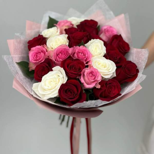 Bouquet of red, pink, and white roses wrapped in pink paper