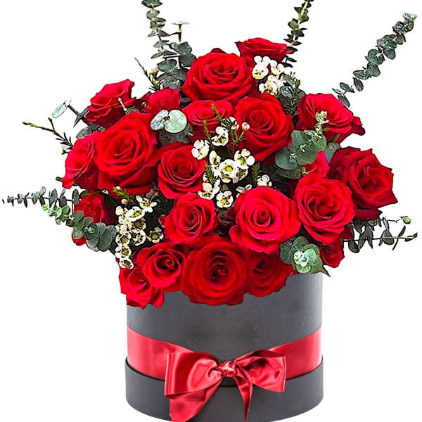 Red roses arranged in a black hatbox with a red ribbon