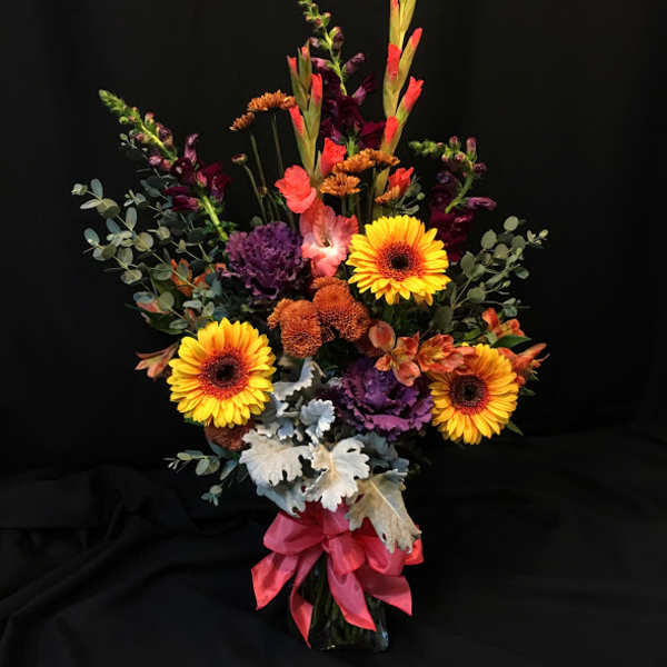Tall mixed bouquet with yellow gerbera daisies in a vase