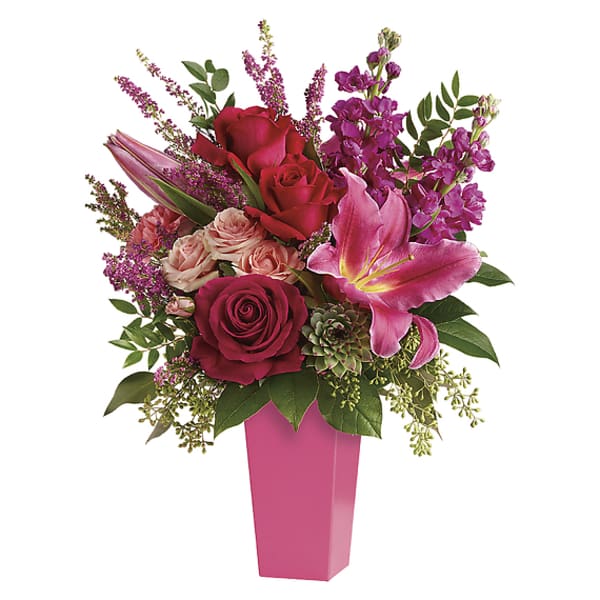 Pink and red floral arrangement in a tall pink vase