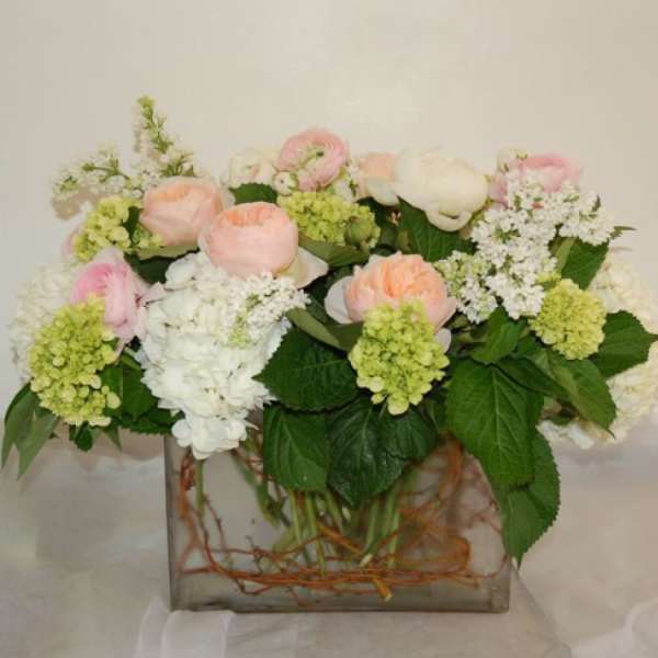 Pastel floral arrangement in a square glass vase